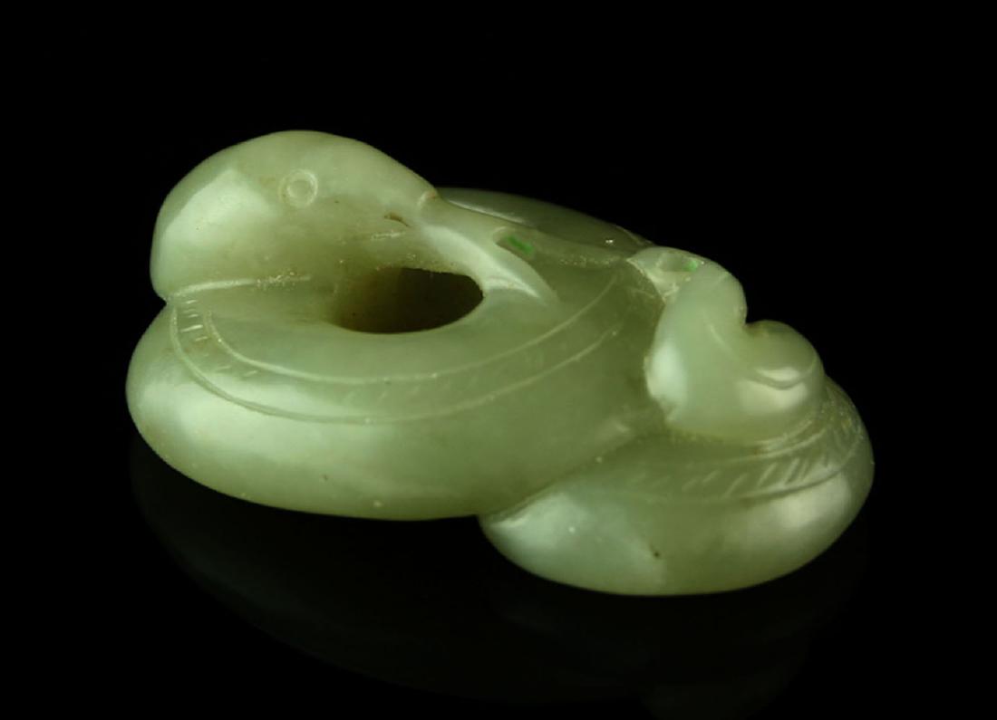 WORLD CLASS QING DYNASTY FORKED TONGUE SERPENT JADE: Exceptional carving with old hand polish. Highly translucent celedon colored Jade. Old Pennsylvania Collection. Can be worn as a pendant, drilled for suspension. Jade is the one stone that comes to mi