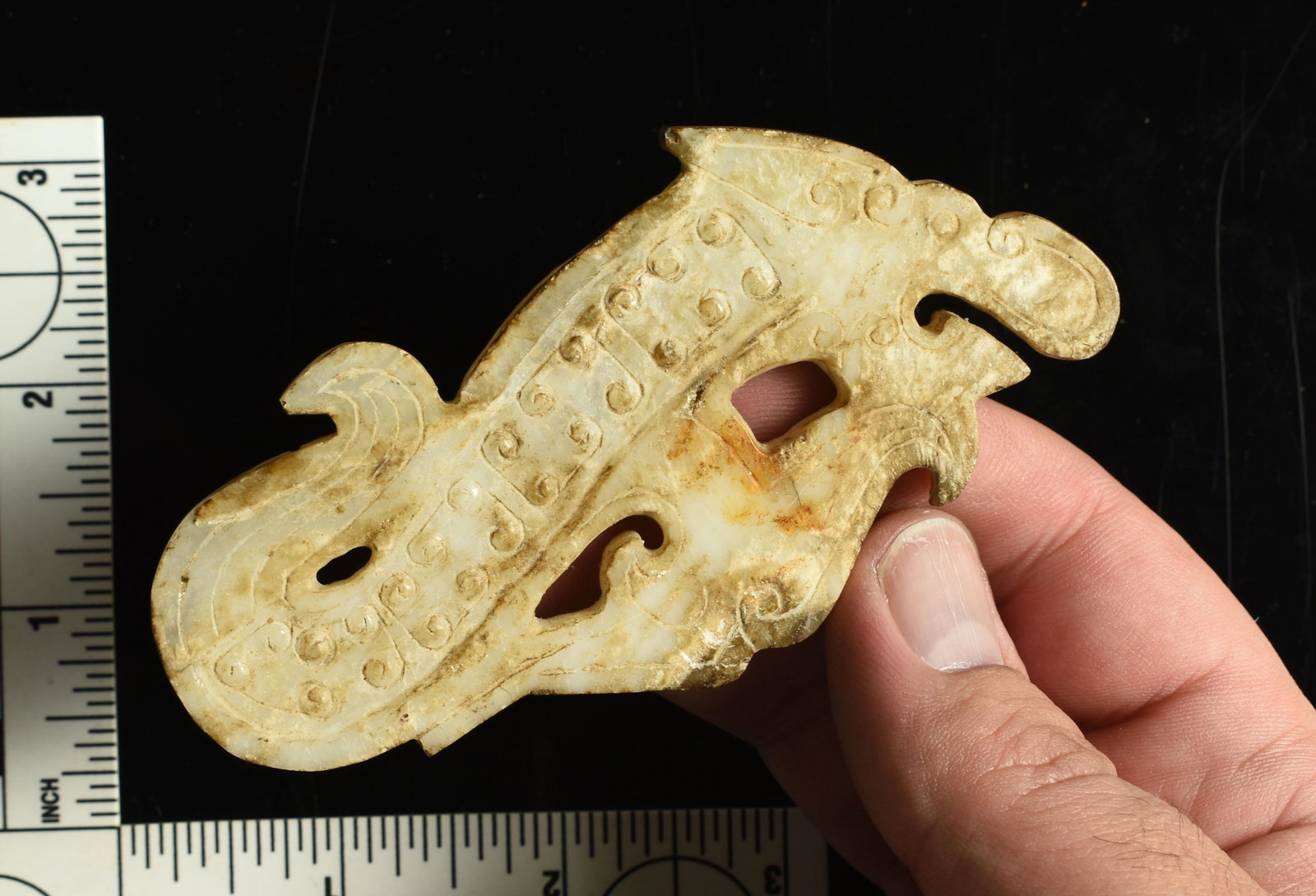Excellent 4 1/8" Chinese Jade Dragon Pendant: Han Dynasty style and could be of the period. Surface exhibits significant differential weathering. Made of highly traslucent white Jade. Intricately carved dragon form with scrolling clouds, rice gra