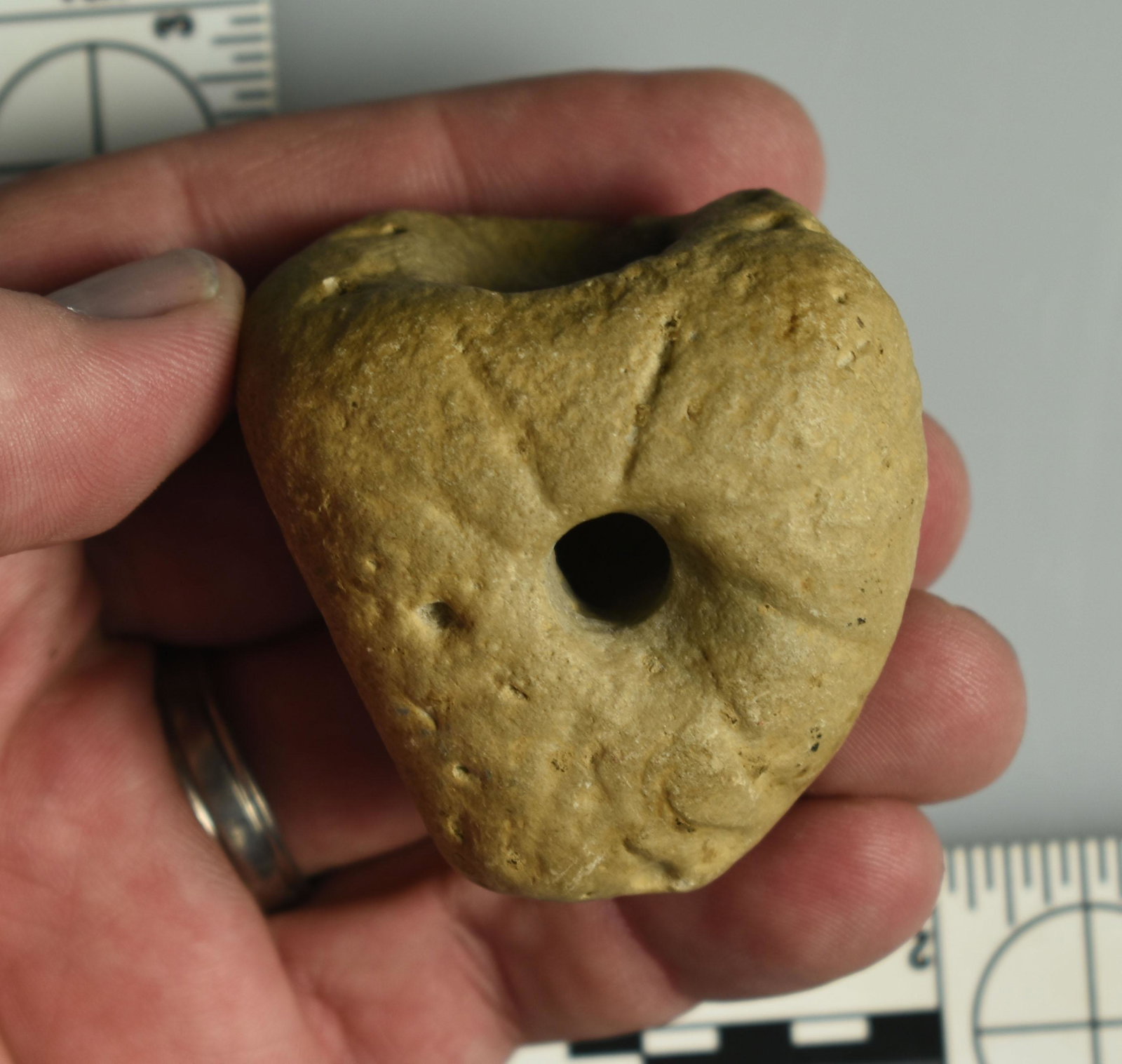 2" Limestone Pipe with ?Pictographs?: Limestone pipe with rays around stem hole, and two other possible effigy figures - one looks like a bird with outstretched wings.. The other, fainter one looks closer to a stick figure animal or human