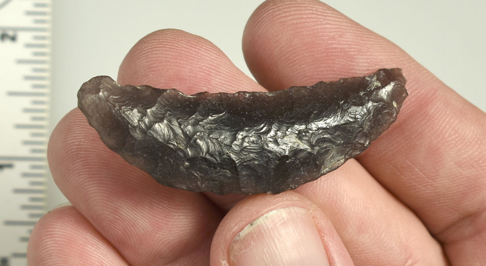 2-3/16" Obsidian Paleo Crescent: Finely flaked example with high translucency. Exceptional. Ex Beckett Collection. Lassen Co., California.