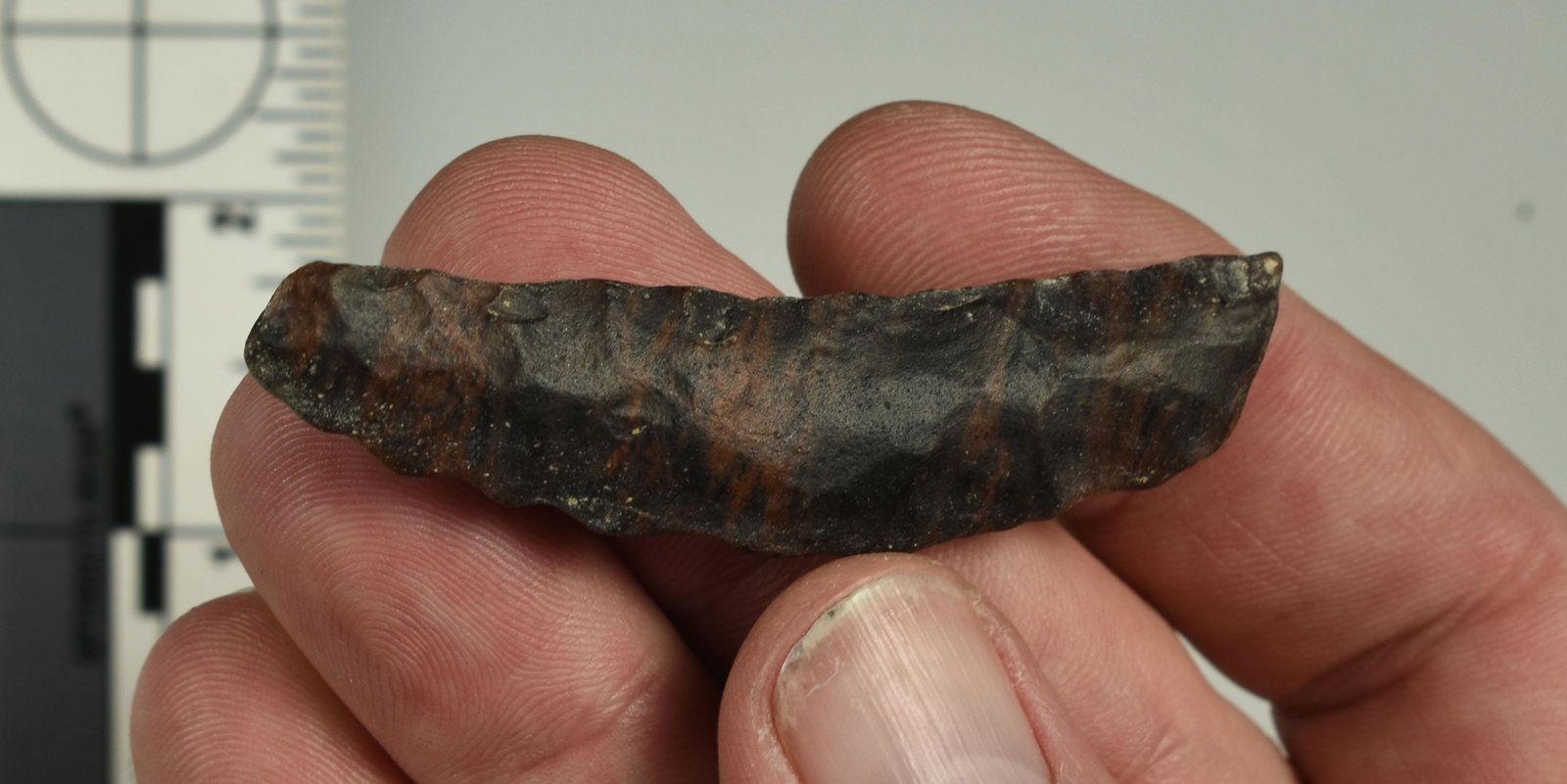 2-5/8" Paleo Crescent: Unique example in Mahogany 'TriFlow' Obsidian. Never seen another one in this material. Ex Beckett Collection. Lassen Co., California.