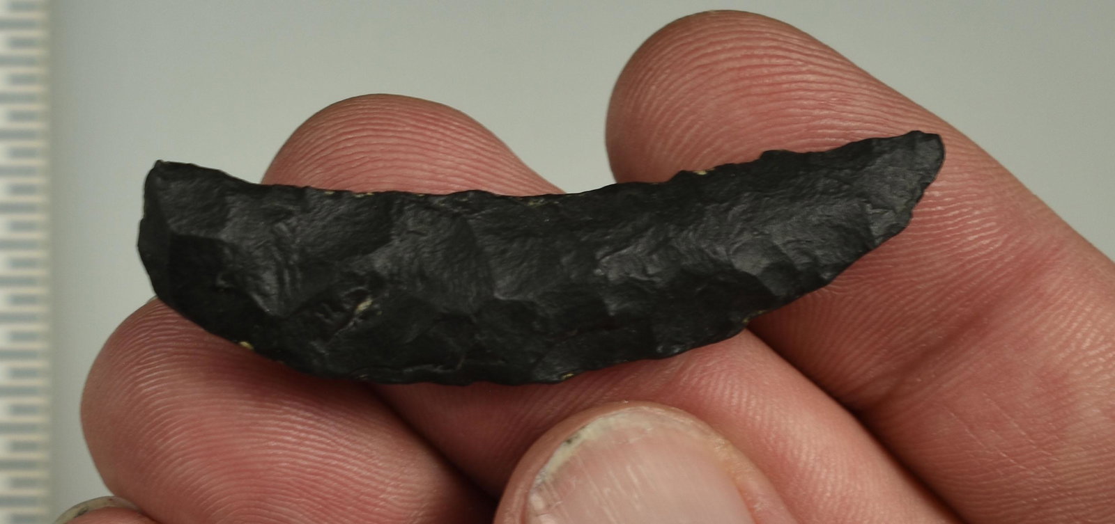 2-3/16" Paleo Crescent: Basalt example flaked on both sides. Ex Beckett Collection. Lassen Co., California.