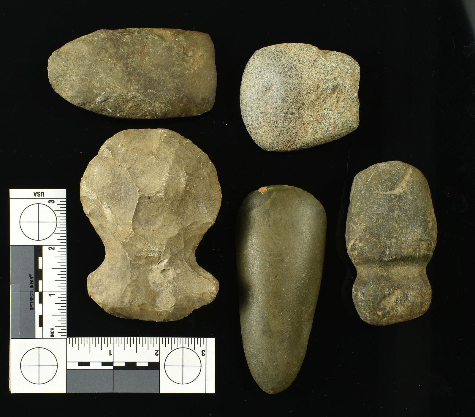 Assortment of 5 Indian Stone Tools: Includes a Tennessee 4 1/4" notched flint axe made of Fort Payne chert. Also a highly polished 4 1/2" greenstone adze repaired on one corner of the bit. Plus a 3 1/2" stone celt found b