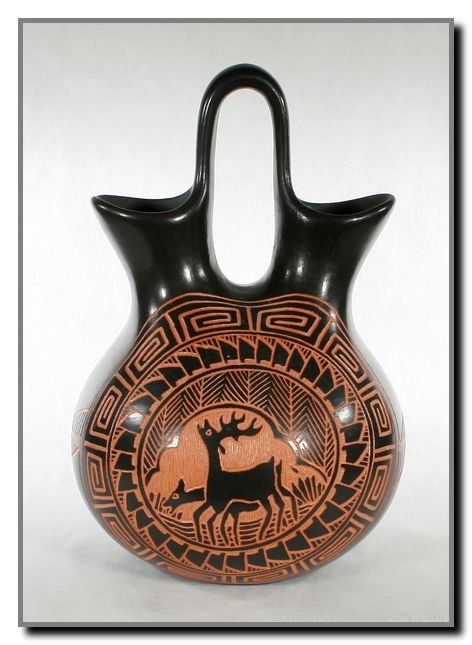 7 7/8"x5 1/4" Acoma Sgraffito Blackware Wedding Va: Excellent incised Sgraffito Wedding Vase signed 'MS Acoma' featuring two deer. Attributed to Melody Simpson award winning Acoma potter. 1980's vintage.
