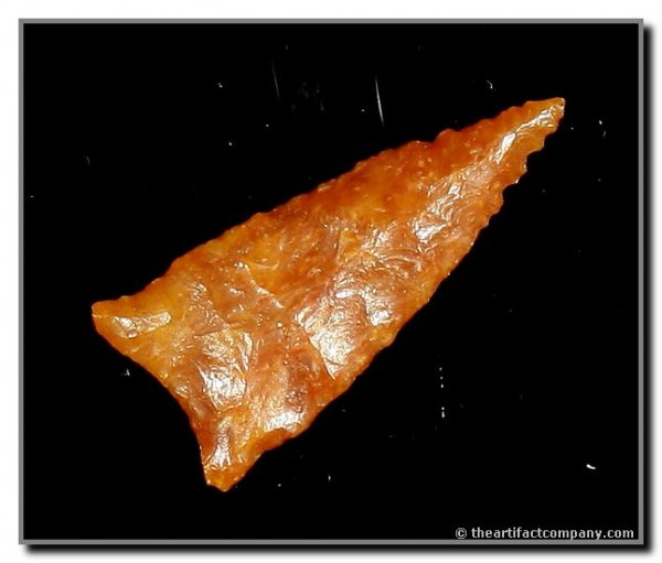 077: 1 5/8" Meserve: River polished orange high grade translucent chalcedony. Ex - Virgil Russell Collection. Baker COA.