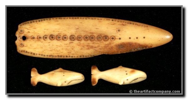 Eskimo Ivory Net Guage & Pair of Ivory Whale Game: Ornately decorated net guage from Alaska in Ivory. Nice set of Ivory Game Pieces from Alaska measuring 1 1/2" each. One tail broken and professionally glued. US BUYERS ONLY