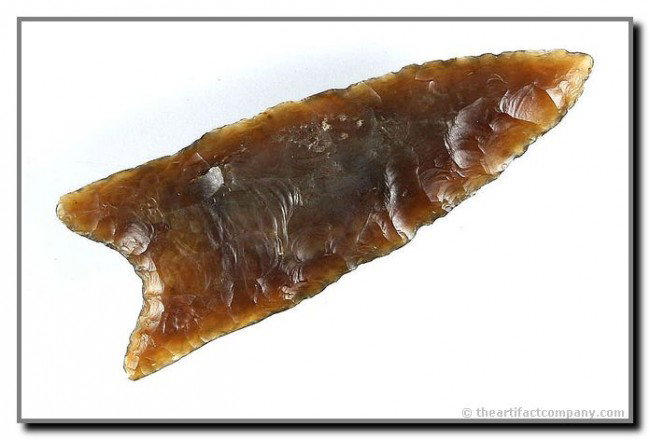 2 13/16" Clovis: A true show-stopper. Crafted of highly translucent Knife River Flint in superb condition. Broadly distinctly fluted 50% on one side and 40% on the other. From Wyoming. G-10 without question. Jackson C