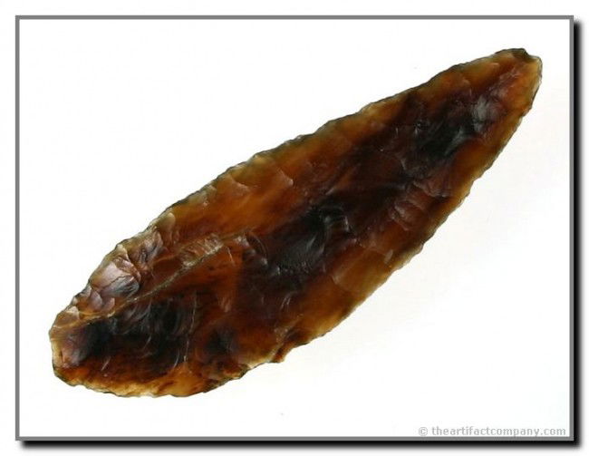 2 5/8" Side Knife: Beautiful root beer colored translucent Knife River Flint. Excellent and rare example. Ex- Harlan Snyder. Found near Red Field, in Faulk Co., South Dakota.