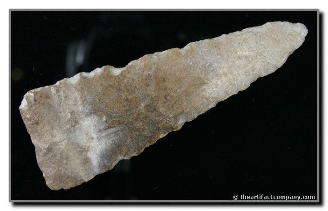 5" Paleo Knife: Broad parallel 'Paleo' flaking. Heavily ground base. Nice and thin. Length and form intact. Pleasingly river polished. Minor edge damage is from tumbling in a ricky river bottom. Found in Oklahoma.