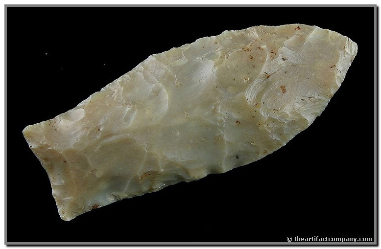 054: 2 1/2" Flint Ridge Coldwater - Stermer, Partain, &: Pretty translucent champagne colored Flint Ridge. Heavily ground basal edges. Interesting twist to the blade with divot/channel on one side. Ex- Charles West Collection. Stermer, Partain, & Howard COA
