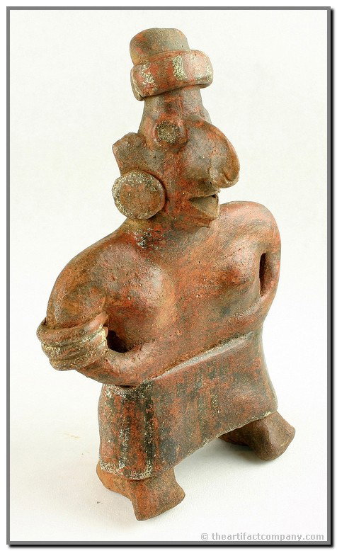 8" Nayarit Figurine: Wonderful example. Has intricate black and white paint on red clay. Ornate earspools, nose ring , and hat. Stands erect. Loaded with manganese deposits. Great addition to any quality Pre-Columbian Col