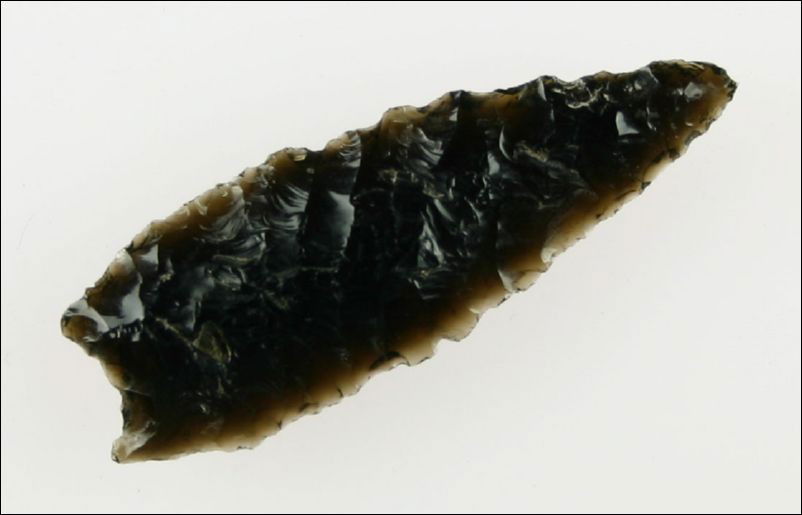 2 3/16" Humboldt Constricted Base: Highly translucent glossy jet black Obsidian. Great serrations. Grteat flaking. Found in Lake Co., Oregon. Ex- Kirkpatrick Collection.