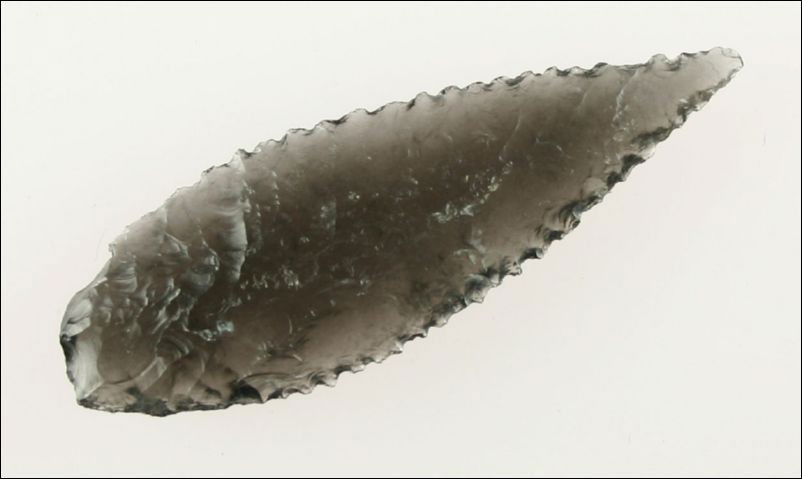 2 5/8" Killer Serrated Cascade: Highly translucent Ice Obsidian. Oblique transverse flaking to die for. Lake Co., Oregon. Ex- Hulse Collection.