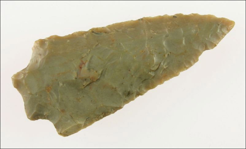 Perfect 2 1/2" Kirk Stemmed: Classic Carter Cave flint. Expertly crafted. Very thin with perfect symmetry and lethal serrations. Old writing reads - 'Montgomery Co., Ky'.