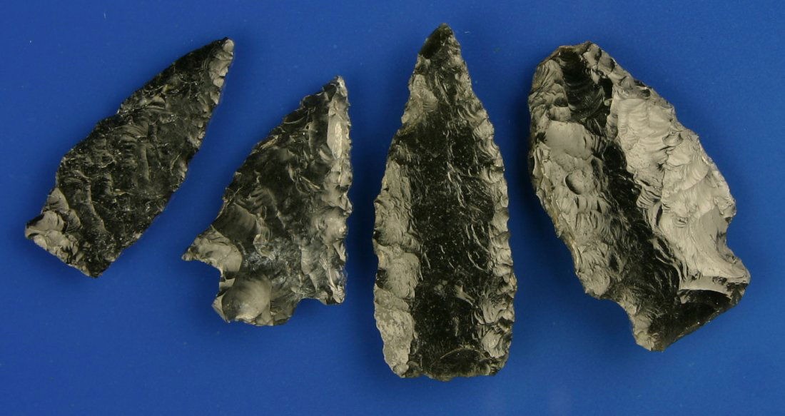 4 Excellent Obsidian Arrowheads: Really nice lethally serrated example. Stemmed point has great flaking and a heavily ground base. Two darts are well made with nice flaking. Biggest is 1 7/8". Lake Co., Oregon. Ex- Butch Clark Collec