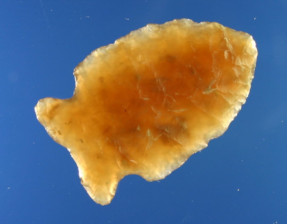 1 7/16" Translucent Knife River Samantha Dart: Highly translucent root beer colored Knife River flint. Thin and excellent. Orinally collected by Lloyd Dugstad of Albert Lea, Minnesota who appeared in Who's Who Vol. 2 on page 59.
