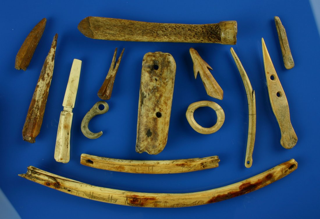 Eskimo Ivory/Bone Artifacts: Excellent assortment of Eskimo artifacts including a 16" carved ivory Bow-Drill featuring depictions of Walrus, Whales, boats, a Polar Bear. Toggles, rings, net-gauges and harpoons. US Buyers only. No