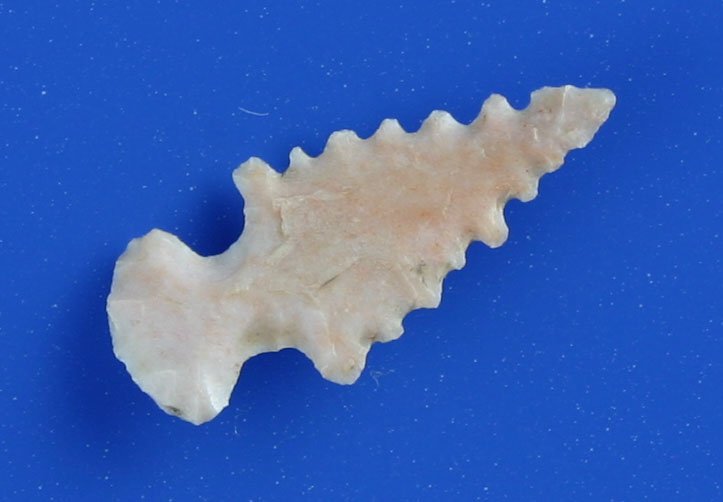 15/16" Keota - Spiro Mound Point: Translucent pink chert serrated to death. Rare type with a needle tip and very thin. Old collection from Spiro Mound.