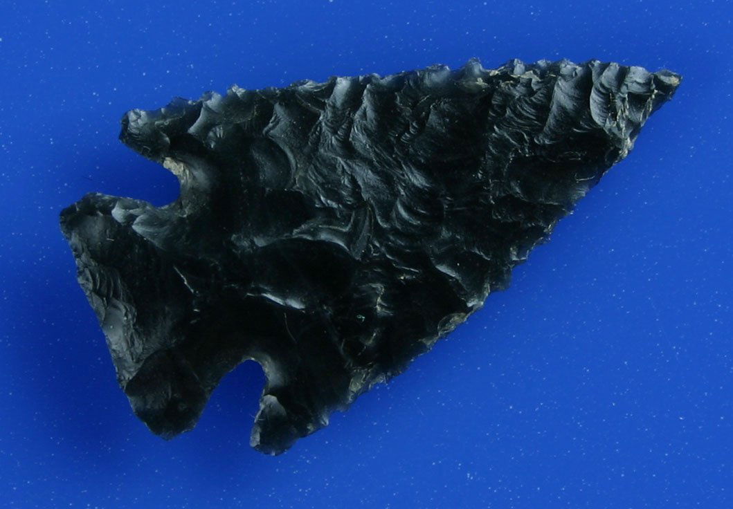 1 3/8" Elko Corner Notch - Pictured in Overstreet: Superb Jet Black glossy Obsidian example with super fine serrations. Pictured on page 1046, Overstreet, 11th Edition. Literally perfect in every detail. Warner Valley, Oregon.