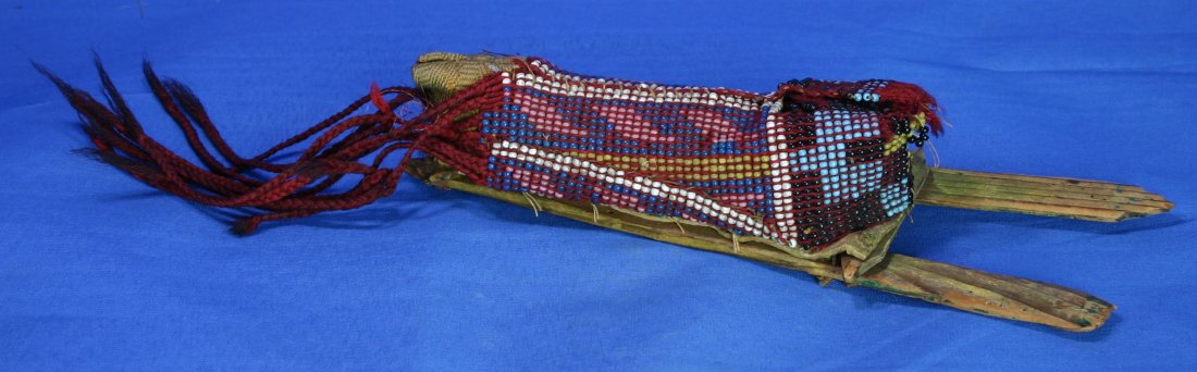 9 1/4" Beaded Cheyenne Toy Cradle: Rare early museum quality Native American piece. Dates to the middle to late 1800's. From an old Montana Collection. Leather, wood, sinew, beads, cloth, woolen fringe, all in excellent condition. Ex- 