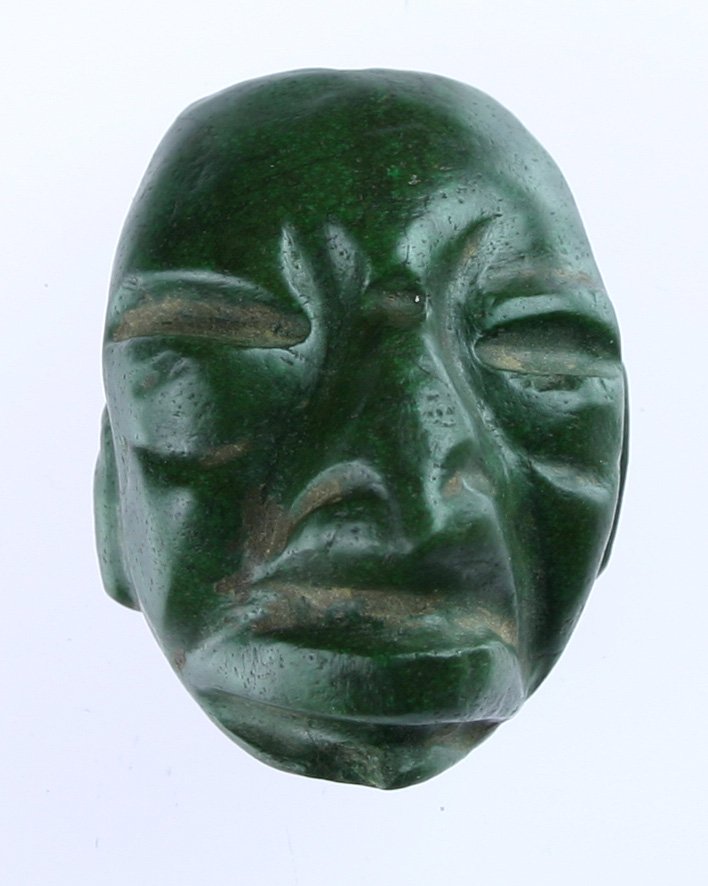 1 7/8"t X 1 5/8"w X 1 1/8"d - Mayan Jade Maskette: Classic example biconically drilled through the top of the forehead for suspension. Nicely details carving. Deeply cupped on the back and highly polished over its entirety. Small chick on chin. Ex- J.