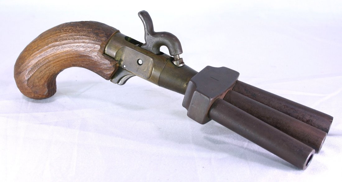 9 3/4" Duck's Foot BlackPowder Volley Pistol: Interesting Blackpowder pistol that takes a single percussion cap to fire all three barrels. Grip with damage. Exact age unknown. Style reportedly used by naval captains as defense against mutiny. A g