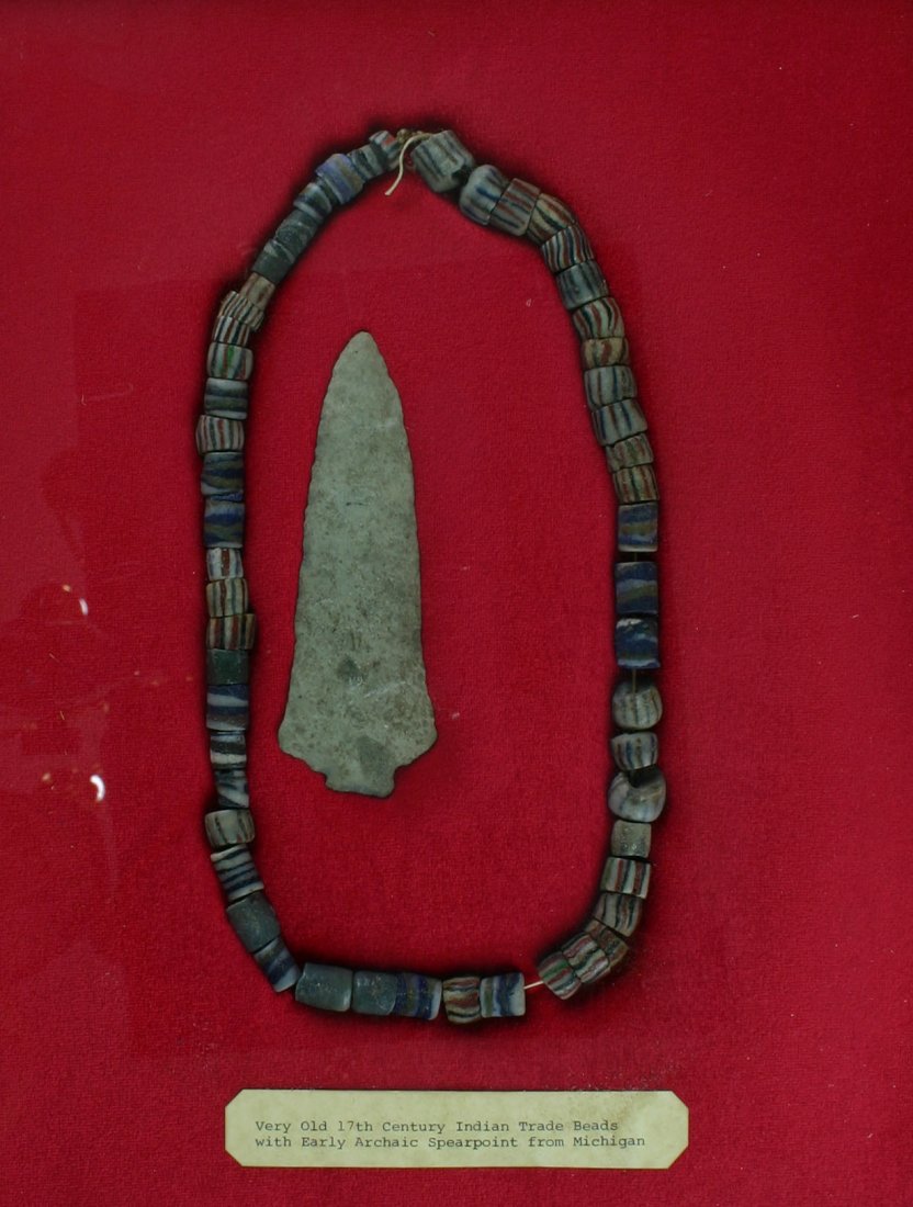 Trade Bead Necklace with Spearpoint: Multicolor strand of trade beads listed as 1600's/1700's in age measuring 24" with a 5 1/8" Bayport Chert Spearpoint from Michigan. Ex - Theodore Kouba Collection.