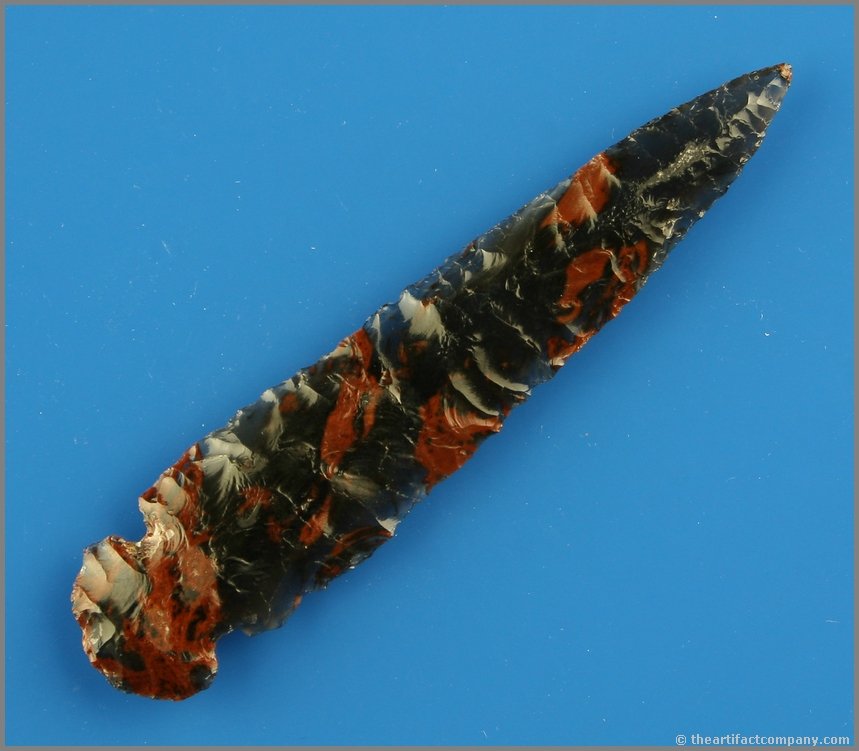 3 5/8" Gorgeous Tri-flow Obsidian Tuolumme Notched: This point is gorgeous beyond belief. Tri-flow obsidian in translucent clear, red, and black. Blade is ultra thin and all there. Found in Lake Co., Oregon. Ex- Bob Rogers Collection. You will marvel f