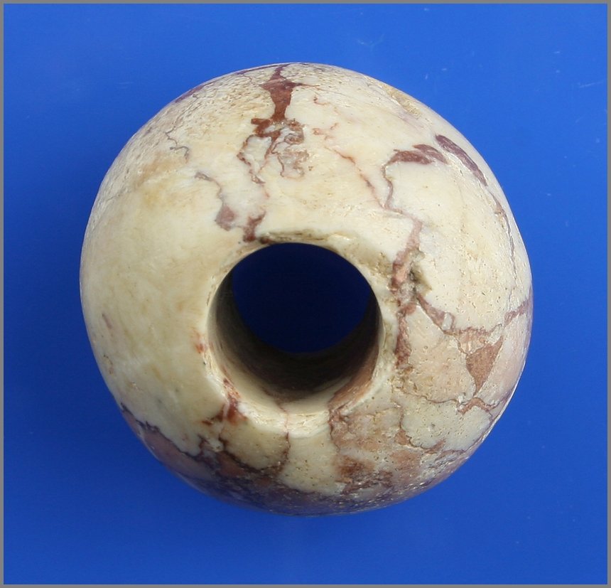 1 3/8" Alabaster Mace Head: Alabaster example with heavy mineralization. Naqada I-II circa 3500-3200 BC. Formerly of the Denten Estate.