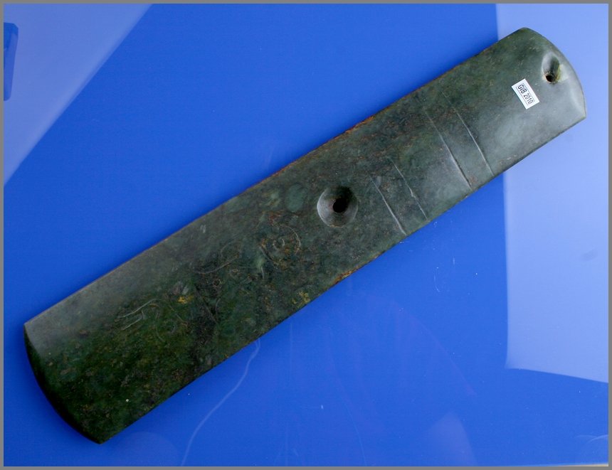 14 3/4" Chinese Jade Axe with Glyphs: Drilled axe made from greenish jade with glyphs and carved bands. Undetermined age.