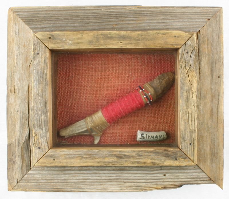 7 1/2" Hafted Knife in Frame: Point appears old. Hafted in bone antler with leather, felt, and beadwork. Old billet say 'Sirmans'(?). Not examined outside frame. Old hand made barnwood shadowbox frame and glass included. No other