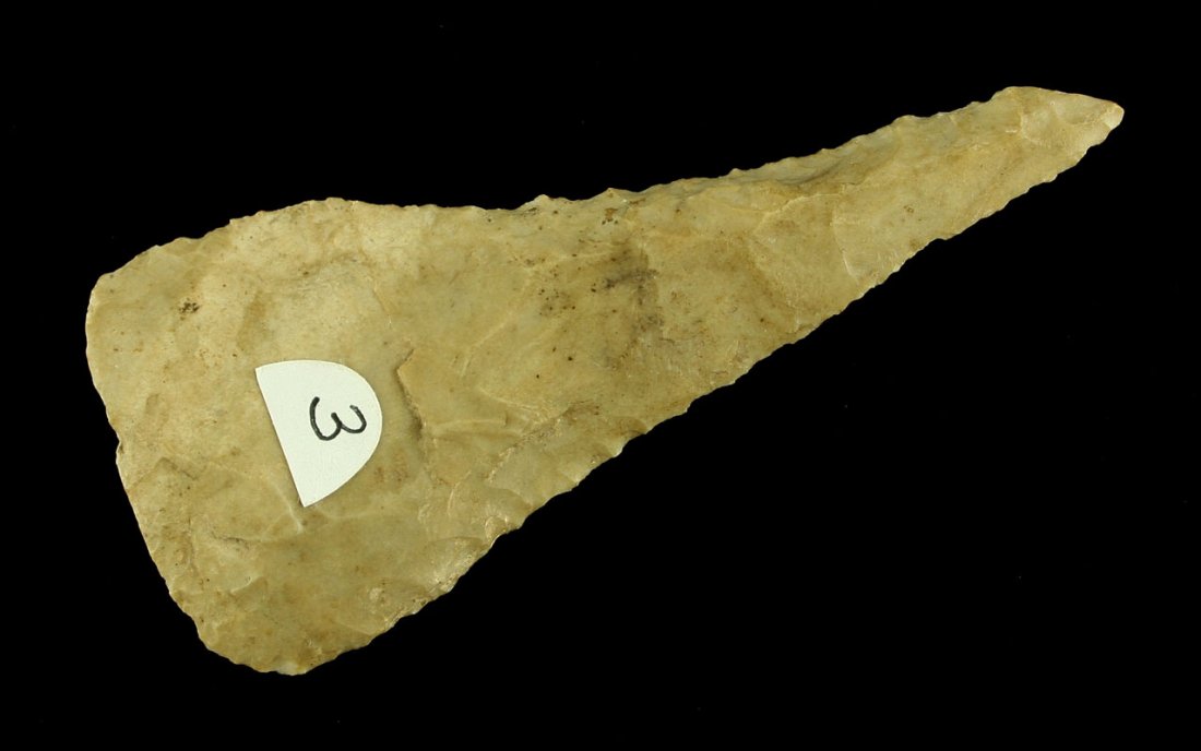 3 3/4" Cobbs Triangle: Creamy brown glossy high grade chert. Serrated edges and a sharp burined tip. Labeled Montgomery Co., Indiana. Old Indiana Collection.