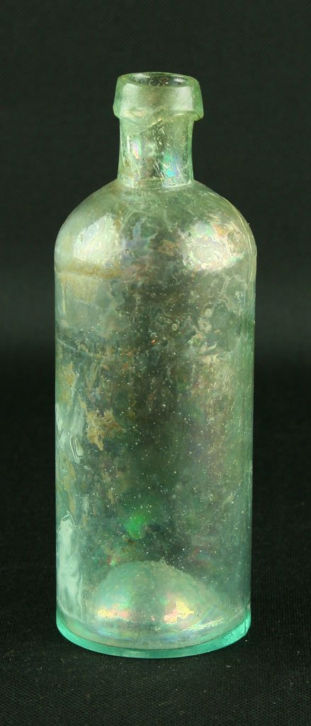 6 1/4" Iridescent Medicine Bottle: Early bottle found by Art Heaton in and around Batavia, Ohio. Has a nickel sized crack to one shoulder but no loss of material.
