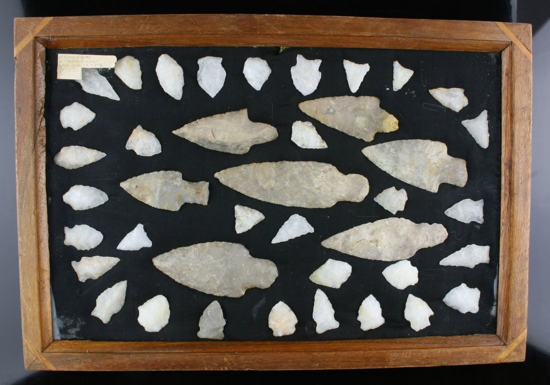 7pc Adena Cache with NC Points: 7 pc Adena Cache in Boyle Chert from the Charlie West, and Kenneth Broughton Collections. Surrounded with 33 White and Vein Quartz points from NC/VA. Includes wood display frame!