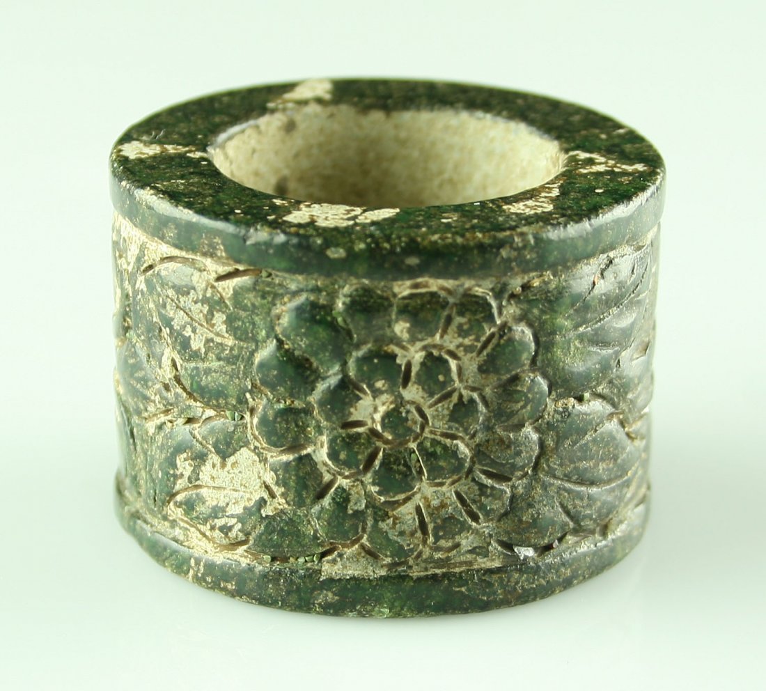 Pretty Ancient Style Chinese Thumb Ring: Intricately carved. Spinach green hardstone (possibly Jade - not tested) thumb or archer's ring. Han Dynasty style. What appears to be calcium accumulation on the inside and some areas of the exterior