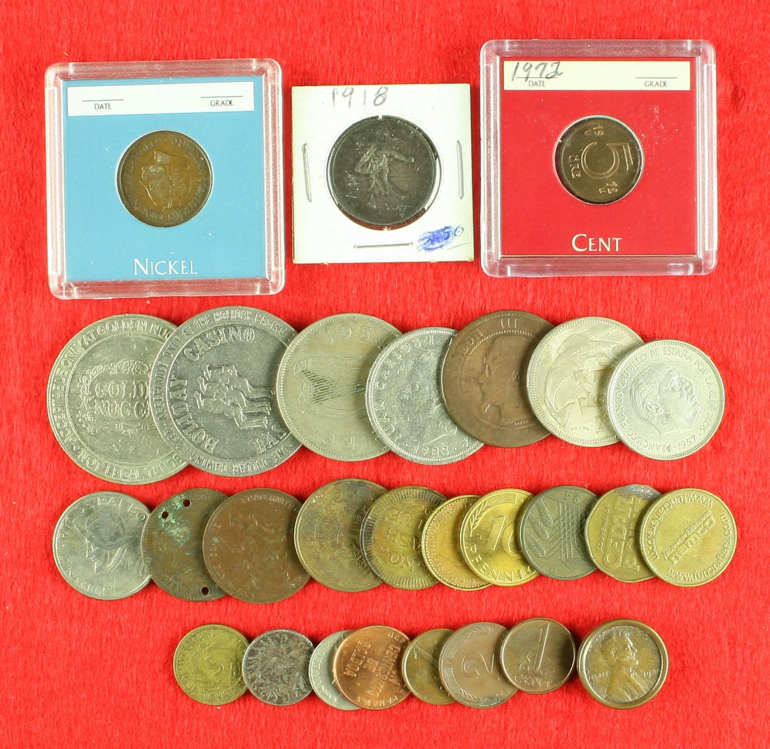 Assortment of old Foreign Coinage & Tokens: French Francs, Irish, Netherlands, German, and Panamanian coins. Also included in this lot are a couple of Casino 'Silver Dollars' for slot machines. Some dates go back to 1918.