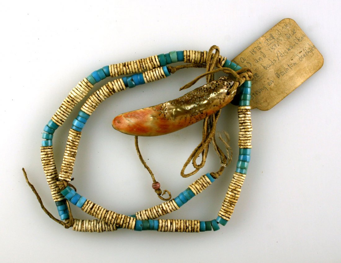 26" 1870's-1880's Trade Bead Necklace: Excellent strand with shell disc beads and blue padres strung on brain tanned leather with a 3 1/2" Abalone shell pendant dating to the 1870's-1880's. Killer.