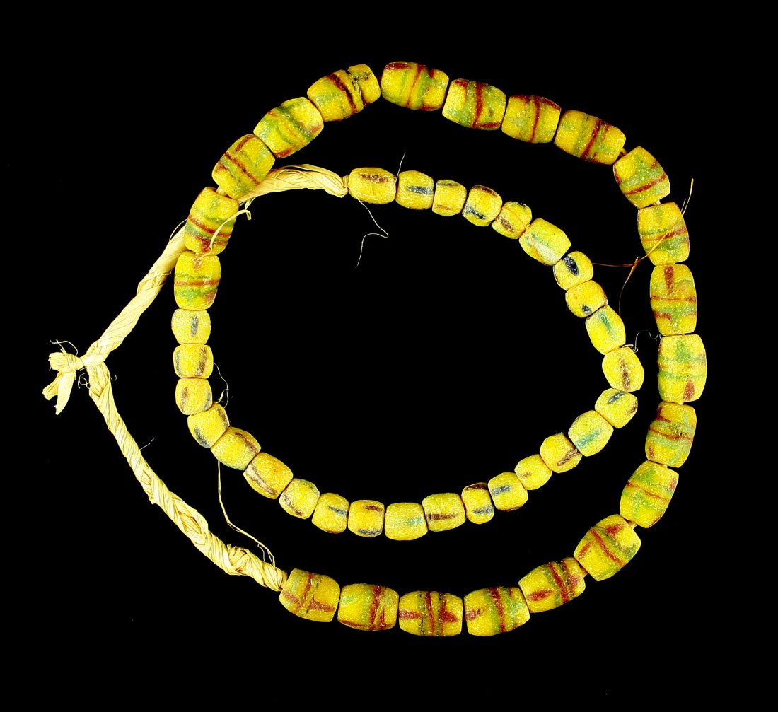 25" Trade Bead Necklace: Sand cast beads in Yellow/maroon/green. Strung on grass.