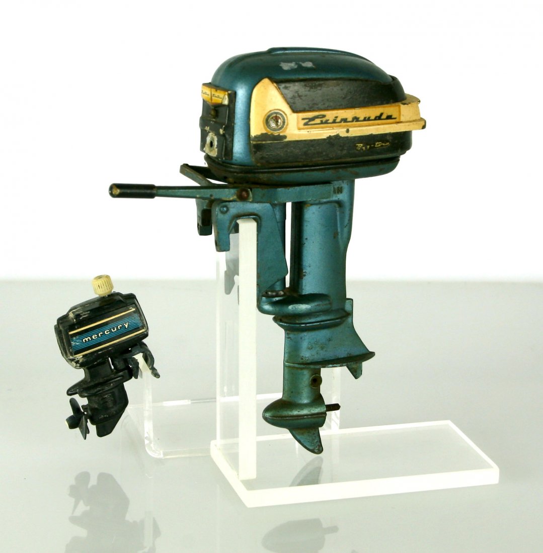Pair of Vintage Model Outboard Motors - Parts only: Evinrude Big Twin from the 1950's, and a Mercury wind-up minature. Evinrude is missing the internals and propeller but could be a nice stationary display.