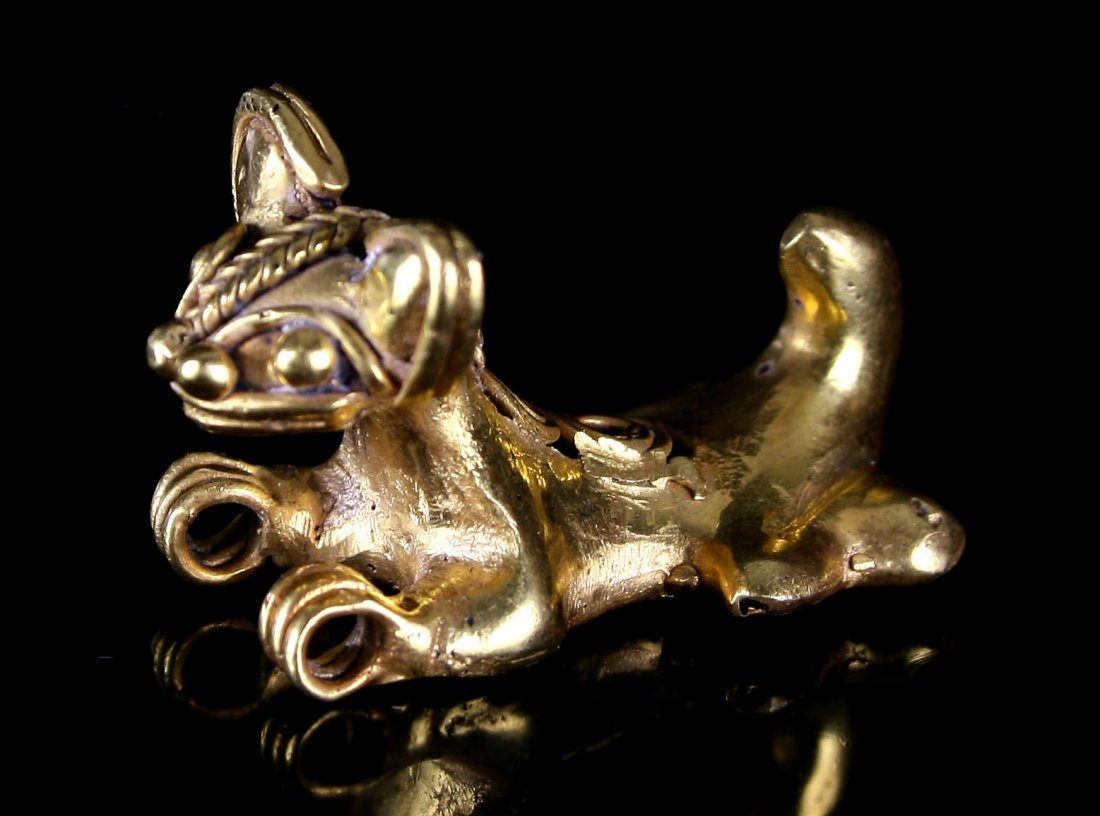 1 1/2" Tairona Animal Effigy Pendant: 9.7 grams of unknown gold content. Colombia. Features a reclining dog with braidwork.
