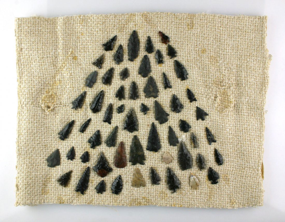 Display of 55 Nevada Obsidian Points: Nicely arranged vintage display from a Reno, Nevada Estate. Mounted on burlap. Measures approx 12x15"