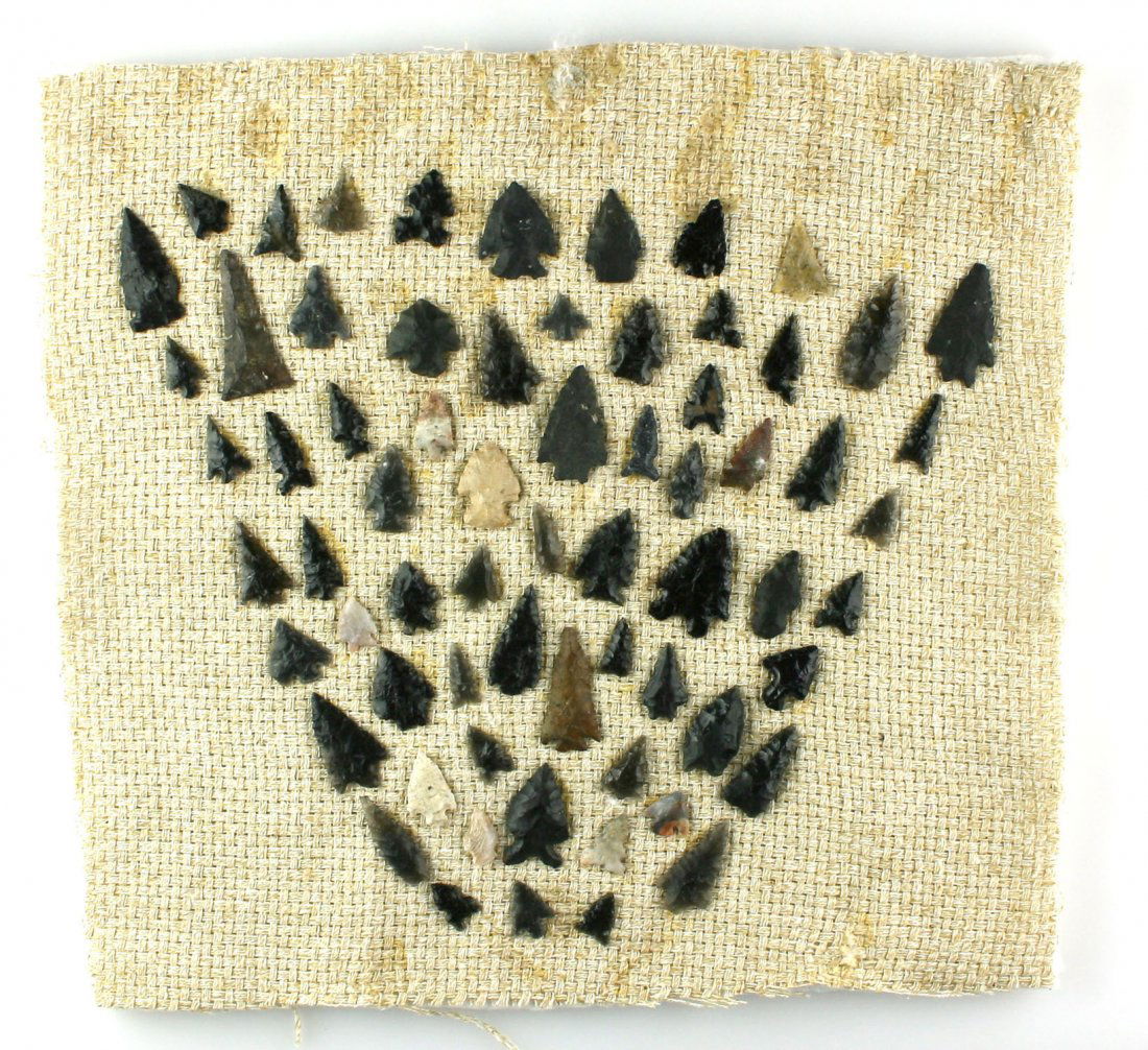 Display of 66 Nevada Obsidian Points: Great display mounted on burlap measuring 12x12". From a Reno, Nevada Estate.