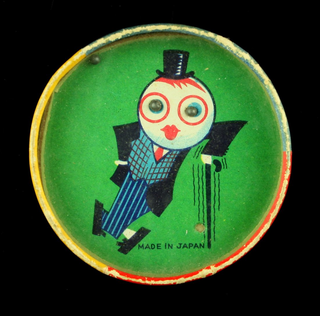 Vintage 1950's Pocket Dexterity Puzzle: Unique example with glass windows. One side is a classic 'Ball in Hole' game, the other, a ring-catch game involving a monkey's tail. Marked 'MADE IN JAPAN'.