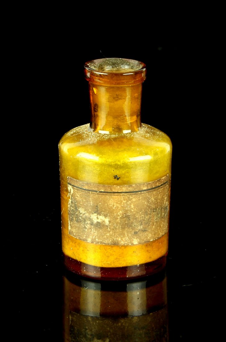 2 3/4" Tincture Bottle: Medicine or possibly an Inkwell bottle which has old label affixed with illegible writing. Amber-Brown Glass. Scotland.