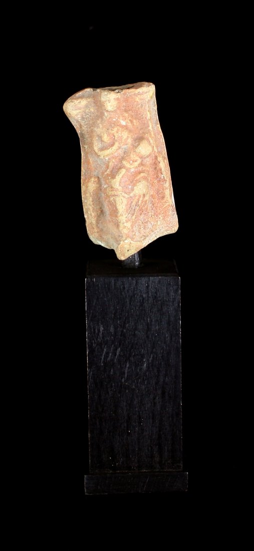 Roman Terracotta Plaque: Plaque depicting a mother cradling a baby. Circa 1st-3rd century AD 2 1/8" tall. Mounted on an attractive wooden base.