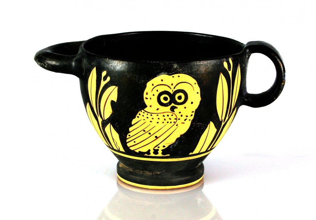 3 1/8" Grecian Apulian Owl Skyphos *restored: Pretty example in black on buff from the Tedder Collection of Los Angeles. Restoration present to the handles and a portion of the base. Atypical handle. Note the Owl Detail