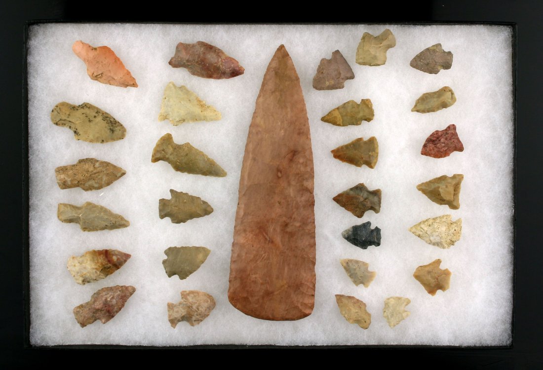 Decorative Only Display of 28 Arrowheads: Display with large blade we feel is a reproduction at its center surrounded by 27 Kentucky Arrowheads. Excellent display/decorative only lot!