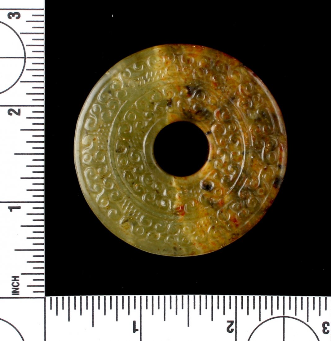 2 3/16" Chinese Pi: Detailed engravings on this example in green translucent jade-like stone. Unknown age.
