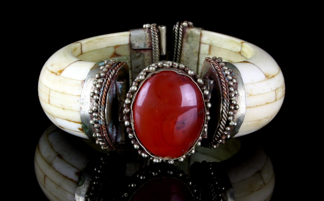 Silver and Warthog Tusk Bracelet: Incredible composite bracelet with silver end caps and inclade agate stone. Dimensions : 3.5x1.4" Exact age unknown but appears early.
