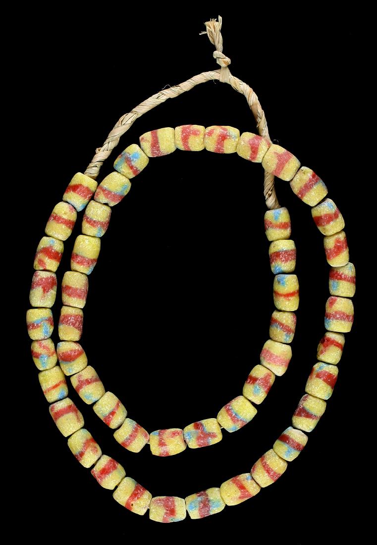27" Trade Bead necklace: Sand cast beads. Yellow and red with blue spots.